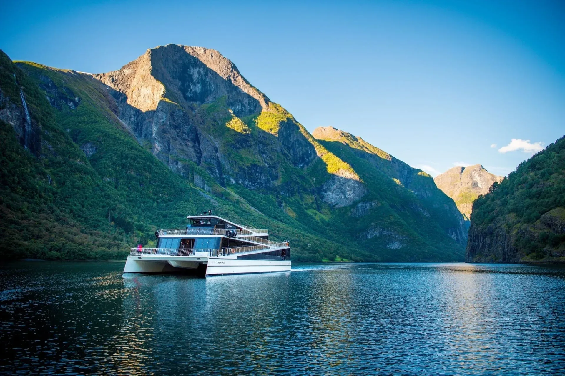 Sightseeing vessel on Nærøyfjord between steep mountains