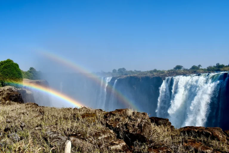 Rainbow above the mist and waterfalls at Victoria Falls